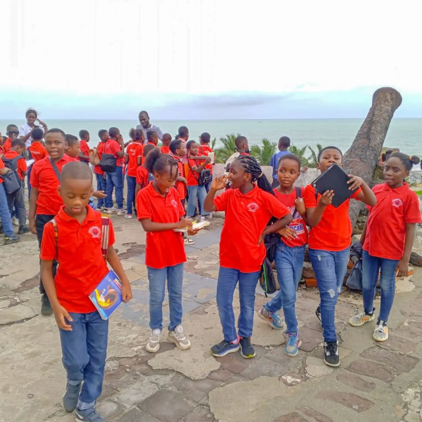 Pupils on an excursion by the sea at Cape Coast